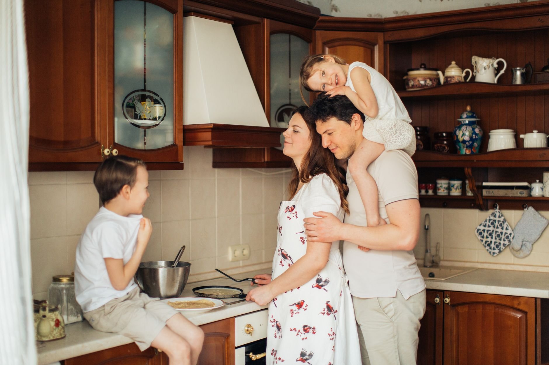 A joyful family cooking together in a cozy farmhouse kitchen